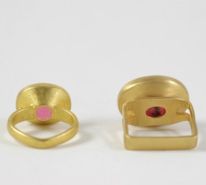 Two gold rings with one pink stone and the other a yellow.