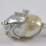 A close up of the side of a pearl necklace