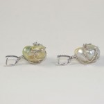 A pair of earrings with pearls and silver.