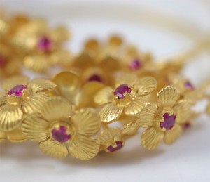 A close up of some gold flowers with red centers