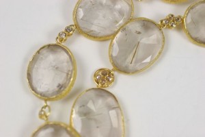 A close up of the gold and clear stones.