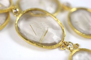 A close up of the gold frame on a necklace