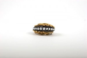 A gold and silver ring with pearls on it.