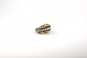 A gold ring with white stones on it