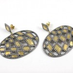 A pair of diamond and gold earrings.