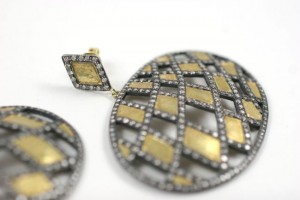 A pair of earrings with diamonds and gold.