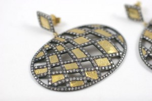 A pair of diamond and gold earrings.