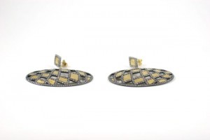 A pair of earrings with gold and black diamonds.