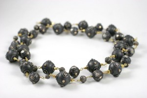 A black bead necklace with gold accents.