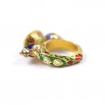 A gold ring with colorful stones on it.