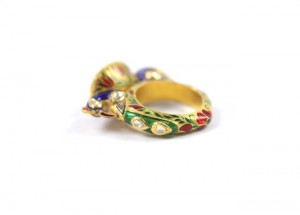 A gold ring with colorful stones on it.