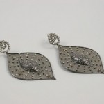 A pair of earrings with diamonds on them.