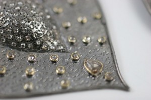 A close up of some silver and gold beads