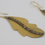 A pair of earrings made from brass and silver beads.