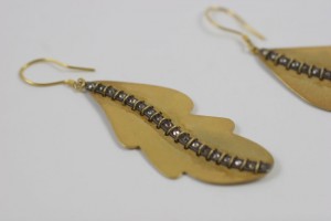 A pair of earrings made from brass and silver beads.