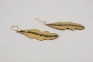 A pair of earrings made from brass and wire.