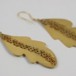 A pair of earrings made from gold leaf.