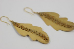 A pair of earrings made from gold leaf.