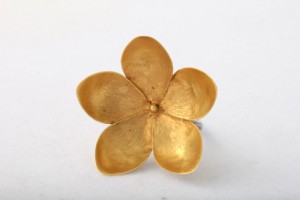 A gold flower is sitting on top of the table.