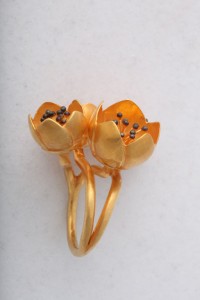 A close up of three flowers on a table
