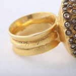 A gold ring with some stones on it