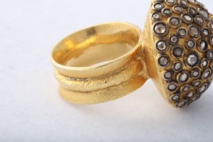 A gold ring with some stones on it