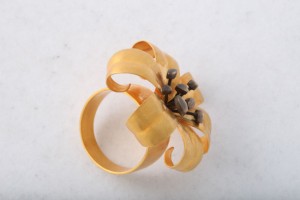 A gold ring with a flower on it