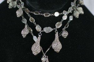 A necklace with many different shapes and sizes of stones.