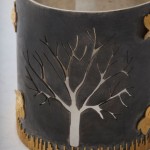 A close up of the tree on the candle holder