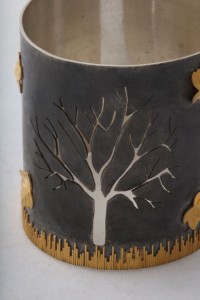 A close up of the tree on the candle holder