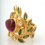 A gold ring with leaves and gemstones