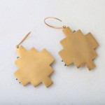 A pair of gold earrings with a cross design.