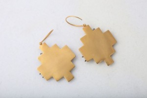 A pair of gold earrings with a cross design.