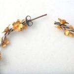 A pair of scissors and some gold flowers