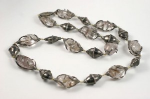 A long necklace of silver beads and glass