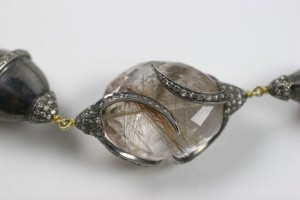 A close up of the necklace with a large stone