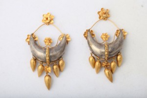 A pair of earrings with gold and silver details.
