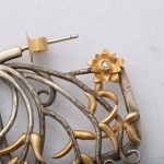 A close up of the ear piece of a pair of earrings