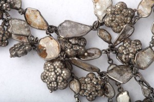 A close up of the necklace on a white surface