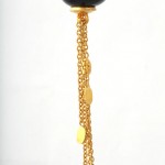 A gold chain hanging from the side of a black object.