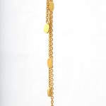 A gold chain with some small yellow stones