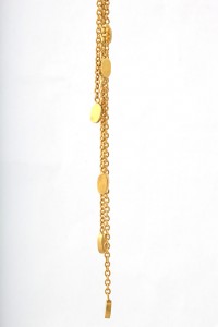 A gold chain with some small yellow stones