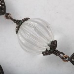 A close up of the glass bead on the necklace