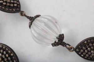 A close up of the glass bead on the necklace