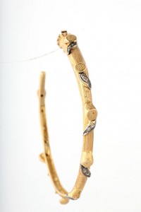 A pair of bamboo earrings with silver leaves.