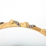 A close up of the side of a gold bracelet