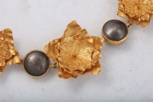 A close up of the gold and black jewelry