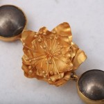 A close up of the gold flower and two balls