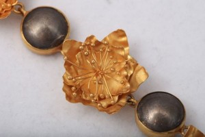 A close up of the gold flower and two balls