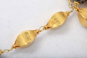 A close up of the gold chain on a necklace
